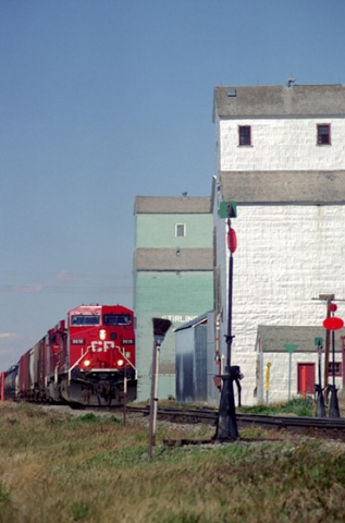  Wooden grain elevators and locomotive at Stirling, Alberta