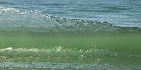 Crystal clear wall of water from a wave.