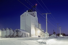 Night photograph of UGG wooden grain elevator at Naicam, Saskatchewan